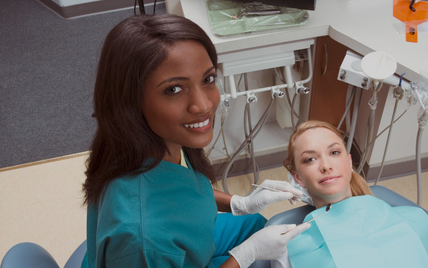 dental hygienist with patient